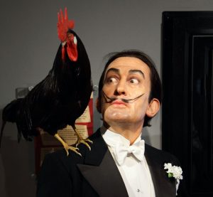 Photograph of Salvador Dali with a cockerell on his shoulder