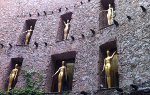 Photograph of golden statues inside a ruined building